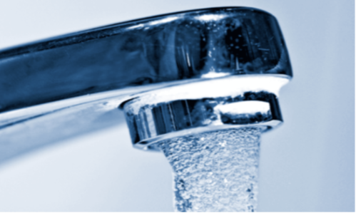 Faucet with water coming out from the tap